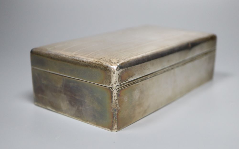 A George V silver mounted rectangular cigarette box, 16.3cm, gross 14oz.